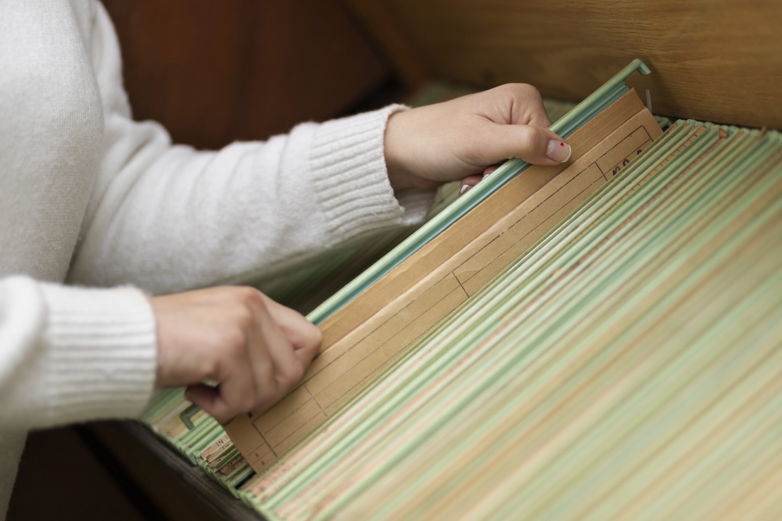 female staff organizing file with the goal of streamlining office operations